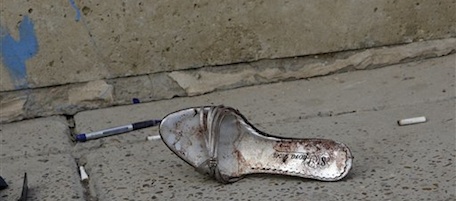 A bloody shoe lies at the scene of a car bomb attack in front of a Syrian Catholic Church, in Baghdad, Iraq, Monday Nov. 1, 2010. Islamic militants held around 120 Iraqi Christians hostage for nearly four hours in a church Sunday before security forces stormed the building and freed them, ending a standoff that left dozens of people dead, U.S. and Iraqi officials said. (AP Photo/Khalid Mohammed)