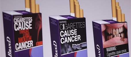 Three examples of proposed warning graphics that will appear on cigarette packaging as part of the government's new tobacco prevention efforts, seen in Washington, Wednesday, Nov. 10, 2010. (AP Photo/Evan Vucci)
