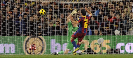 Barcelona's midfielder Xavi Hernandez (Front) scores his team's first goal to Real Madrid's goalkeeper and captain Iker Casillas during the Spanish league "clasico" football match FC Barcelona vs Real Madrid on November 29, 2010 at Camp Nou stadium in Barcelona. AFP PHOTO/ JAVIER SORIANO (Photo credit should read JAVIER SORIANO/AFP/Getty Images)