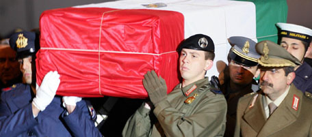 ROME, ITALY: The coffin with the body of Italian intelligence officer Nicola Calipari arrives at Rome's Ciampino airport 05 March 2005. Nicola Calipari, 51, was hit in the head as he was trying to protect Italian journalist Giuliana Sgrena from a hail of bullets by US troops firing at the convoy after her release 04 March in Baghdad. AFP PHOTO/ Vincenzo PINTO (Photo credit should read VINCENZO PINTO/AFP/Getty Images)