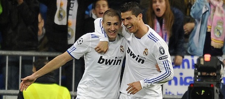 Real Madrid's French forward Karim Benzema (L) celebrates with Real Madrid's Portuguese forward Cristiano Ronaldo after scoring his second goal during the UEFA Champions League football match Real Madrid vs AJ Auxerre on December 8, 2010 at Santiago Bernabeu stadium in Madrid. AFP PHOTO/ DOMINIQUE FAGET (Photo credit should read DOMINIQUE FAGET/AFP/Getty Images)