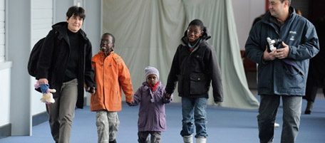 French adoptive parents exit with their children fom Haiti, the Roissy-en-France airport, outside Paris, after their arrival on a French government-chartered plane carrying from Port-au-Prince 114 Haitian children. A total of 318 adopted Haitian children are included in a special programme to bring them to France after disruptions caused by the devastating earthquake that ravaged the impoverished country nearly a year ago. 
 AFP PHOTO / BERTRAND GUAY (Photo credit should read BERTRAND GUAY/AFP/Getty Images)