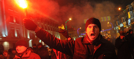 A protester holds a flare during a protest march in the central of Minsk on December 19, 2010. Thousands of opposition supporters massed in Minsk to protest elections that exit polls said were swept by President Alexander Lukashenko, after police used violence to disperse demonstrators. AFP PHOTO/ SERGEI SUPINSKY (Photo credit should read SERGEI SUPINSKY/AFP/Getty Images)