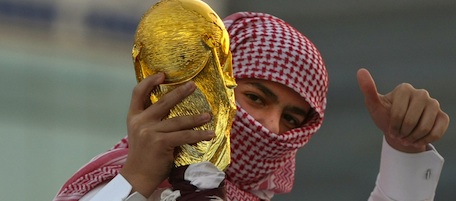 A Qatari youth holds a mock World Cup trophy during celebrations in Doha on December 3, 2010 a day after the world football's governing body FIFA announced that the tiny Gulf state will host the 2022 World Cup. AFP PHOTO/MARWAN NNAAMANI (Photo credit should read MARWAN NAAMANI/AFP/Getty Images)
