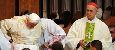 Pope Benedict XVI (L) is helped to get dressed under the look of Vatican secretary of State Tarcisio Bertone (R) during a solemn mass consecrating the Sagrada Familia in a basilica on November 7, 2010, in Barcelona, during his two-day visit in Spain. Pope Benedict XVI warned of a very strong clash between faith and modernity in Spain and he called for dialogue, not confrontation. The pontiff said an anti-clerical movement erupted in Spain in the 1930s in the run-up to the Spanish Civil War. AFP PHOTO/ RAFA RIVAS (Photo credit should read RAFA RIVAS/AFP/Getty Images)