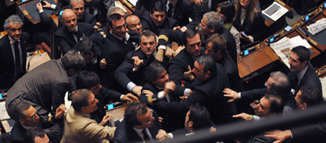 Members of the Northern League and Futura e Liberta (FLI) groups at the parliament argue during a confidence vote at the Chamber of Deputies, the Italian lower house, on December 14, 2010 in Rome. Italy held its breath as lawmakers staged a knife-edge confidence vote on Prime Minister Silvio Berlusconi's government that could bring down the flamboyant Italian leader. AFP PHOTO / ANDREAS SOLARO (Photo credit should read ANDREAS SOLARO/AFP/Getty Images)