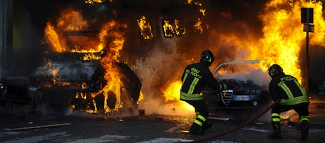 Firemen extinguish a car set on fire at Piazza del Popolo after clashes with youths during a protest to demand a change of government as parliament met to hold a crucial vote that could topple Prime Minister Silvio Berlusconi on December 14, 2010 in Rome. Italian Prime Minister Silvio Berlusconi scraped through a crucial confidence vote in the lower house of parliament by 314 votes in favour and 311 against. AFP PHOTO / FILIPPO MONTEFORTE (Photo credit should read FILIPPO MONTEFORTE/AFP/Getty Images)