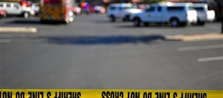 Emergency officials work at the scene of a shooting that authorities claim involved Rep. Gabrielle Giffords, D-Ariz., Saturday, Jan. 8, 2011, at a Safeway grocery store in Tucson, Ariz. (AP Photo/Chris Morrison)