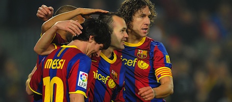 Barcelona's midfielder Andres Iniesta (2ndR) is congratuled by Barcelona's Argentinian forward Lionel Messi (L) and Barcelona's captain Carles Puyol (R) after scoring a goal during the Spanish league football match FC Barcelona vs Malaga CF on January 16, 2011 at the Camp Nou stadium in Barcelona. AFP PHOTO/ LLUIS GENE (Photo credit should read LLUIS GENE/AFP/Getty Images)