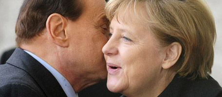 German Chancellor Angela Merkel (R) greets Italian Prime Minister Silvio Berlusconi during an official welcoming ceremony at the chancellery in Berlin January 12, 2011 before leading German-Italian government talks set to be dominated by the euro crisis as speculation grows that Portugal will need a multi-billion-euro rescue. AFP PHOTO / JOHN MACDOUGALL (Photo credit should read JOHN MACDOUGALL/AFP/Getty Images)