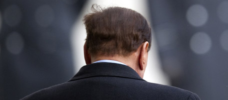 Italian Prime Minister Silvio Berlusconi looks on during an official welcoming ceremony with German Chancellor Angela Merkel (unseen) at the chancellery in Berlin on January 12, 2011 prior to German-Italian government talks set to be dominated by the euro crisis as speculation grows that Portugal will need a multi-billion-euro rescue. AFP PHOTO / JOHANNES EISELE (Photo credit should read JOHANNES EISELE/AFP/Getty Images)