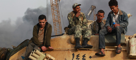 CAIRO, EGYPT - JANUARY 29: People sit on an army tank in Tahrir Square on January 29, 2011 in Cairo, Egypt. Tens of thousands of demonstrators have taken to the streets across Egypt in Cairo, Suez, and Alexandria to call for the resignation of President Hosni Mubarak. Riot police and the Army have been sent into the streets to quell the protests, which so far have claimed 32 lives and left more than a thousand injured. (Photo by Peter Macdiarmid/Getty Images)