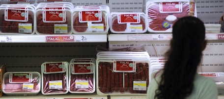 This picture taken on August 21, 2009 in Illzach, eastern France, shows a customer passing by Halal butchery shelves in a supermarket, on the eve of the beginning of the Ramadan. The start of the ninth and holiest month of the Muslim calendar is traditonally determined by the sighting of the new moon, often dividing rival Islamic countries and sects over the exact date. During Ramadan, Muslims are required to abstain from food, drink and sex from dawn until dusk as life slips into a lower gear during the day. Activity peaks between "iftar," the breaking of the fast at sunset, and "suhur", the last meal of the day before sunrise. AFP PHOTO / SEBASTIEN BOZON (Photo credit should read SEBASTIEN BOZON/AFP/Getty Images)