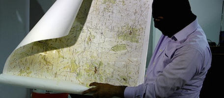 A masked Lebanese secret service officer shows to the media at the Lebanese security services headquarters in Beirut on May 11, 2009 a map found with arrested Lebanese nationals accused of spying for Israel. Lebanese authorities have arrested at least 17 suspected spies working for the Jewish state since January. Lebanon and Israel are technically at war and if found guilty the suspected spies could be sentenced to death on charges of high treason. AFP PHOTO/JOSEPH BARRAK (Photo credit should read JOSEPH BARRAK/AFP/Getty Images)