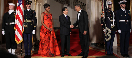 WASHINGTON, DC - JANUARY 19: U.S. President Barack Obama (R) shakes hands with Chinese President Hu Jintao (C) as first lady Michelle Obama looks on as they pose for the official photo at the Grand Staircase of the White House January 19, 2011 in Washington, DC. Obama is hosting a state dinner for Hu this evening. (Photo by Alex Wong/Getty Images) *** Local Caption *** Barack Obama;Hu Jintao;Michelle Obama