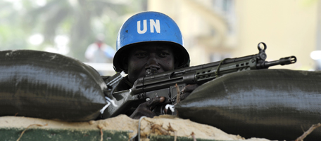 A UN peacekeeker stands guard on January 1, 2011 outside of a hotel in Abidjan which is serving as the headquarters for the internationally recognised winner of the Ivorian presidential election Alassane Ouattara. Nigerian President Goodluck Jonathan said the West African regional body Economic Community Of West African States (ECOWAS) will decide on "further steps" to address the political standoff in Ivory Coast by January 4, 2010, according to a statement. Self-proclaimed Ivorian president Laurent Gbagbo vowed not to yield to growing pressure to cede power to Ouattara, the internationally recognised winner of a November 28 presidential election. AFP PHOTO/ ISSOUF SANOGO (Photo credit should read ISSOUF SANOGO/AFP/Getty Images)