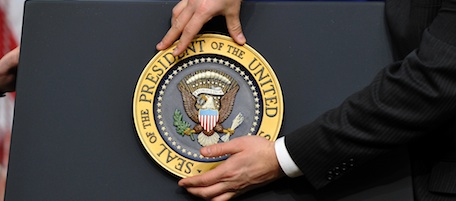A staff fixes the presidential seal before US President Barack Obama gives a press conference in the Eisenhower Executive Office Building at the White House in Washington, DC, on December 22, 2010. Obama celebrated the Senate ratification of a nuclear arms reduction treaty with Russia, saying it "sends a powerful signal to the world." AFP PHOTO/Jewel Samad (Photo credit should read JEWEL SAMAD/AFP/Getty Images)