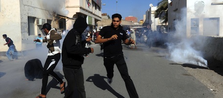 Bahraini protestors run for cover after police fired tear gas canisters to disperse them in the village of Diraz, northwest of Bahrain, on February 14, 2011 during a demonstration called for on Facebook and inspired by similar initiatives which led to the ouster of the regimes in Tunisia and Egypt. AFP PHOTO/STR (Photo credit should read -/AFP/Getty Images)