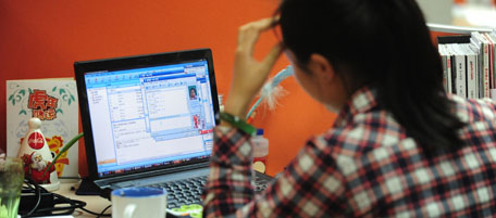 To go with AFP story by Francois Bougon: LIFESTYLE-CHINA-US-IT-INTERNET-GOOGLE
A woman works online in her cubicle at an office in Beijing on February 4, 2010. China's homegrown social media sites like Weibo are booming thanks to their better knowledge of the world's largest Internet market, and the censorship stifling foreign rivals like Facebook, Twitter, and Google-owned YouTube. AFP PHOTO/Frederic J. BROWN (Photo credit should read FREDERIC J. BROWN/AFP/Getty Images)