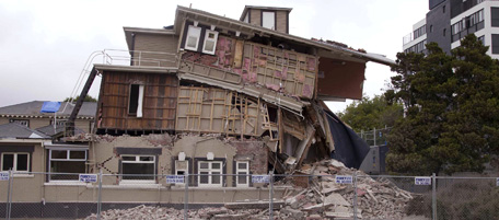 A collapsed building is barricaded following an earthquake in Christchurch, New Zealand, Tuesday, Feb. 22, 2011. A powerful earthquake collapsed buildings at the height of a busy workday Tuesday, killing and trapping dozens in one of the country's worst natural disasters. (AP Photo/New Zealand Herald) NEW ZEALAND OUT, AUSTRALIA OUT