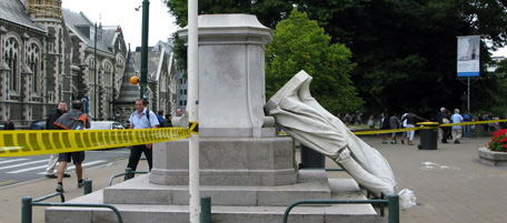 People walk past a fallen statue in the aftermath of a 6.3 magnitude earthquake in Christchurch on February 22, 2011. At least 65 people died in the quake Prime Minister John Key said, adding that the death toll was likely to rise after the lunchtime tremor in the city in the South Island's Canterbury region, which is still recovering from a 7.0 quake in September last year. AFP PHOTO / SHARON DAVIS (Photo credit should read Sharon Davis/AFP/Getty Images)