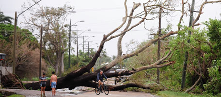 TOWNSVILLE, AUSTRALIA - FEBRUARY 03: A fallen tree is seen laying across a street after the passing of Cyclone Yasi on February 3, 2011 in Townsville, Australia. So far no deaths or serious injuriees have been reported following Cyclone Yasi which struck land as a category five storm around midnight yesterday. The Queensland towns of Innisvail, Mission Beach, Tully and Cardwell where hit hardest by Yasi with authorities waiting for safer conditions to assess the full extent of the damage. Yasi has been downgraded to a category two storm as it passes inland. (Photo by Ian Hitchcock/Getty Images)