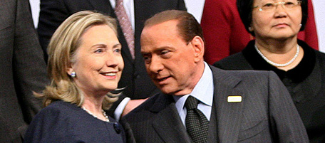 US Secretary of State Hillary Clinton (L) speaks with Italian Prime Minister Silvio Berlusconi (C) as they pose during a family photo session of the OSCE Summit in Astana on December 1, 2010, with Kyrgyzstan President Roza Otunbayeva (R) attending. After a two-decade drive to raise the world profile of an energy-rich nation, Kazakhstan's showpiece new capital held the biggest gathering in its history, the first summit of the the Organisation for Security and Cooperation in Europe (OSCE) in a decade, despite concerns over rights in the ex-Soviet state.. AFP PHOTO/ PRESIDENTIAL PRESS-SERVICE POOL/ANDREY MOSIENKO (Photo credit should read ANDREY MOSIENKO/AFP/Getty Images)