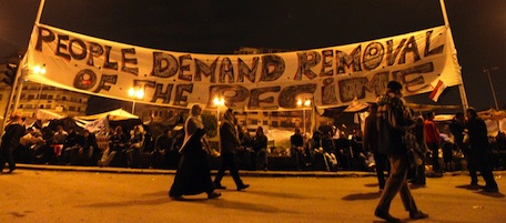 Egyptian anti-government demonstrators gather near a banner at Tahrir Square in Cairo on February 6, 2011 on the 13th day of protests calling for the ouster of President Hosni Mubarak. Opponents of Mubarak's embattled regime dismissed as insufficient an offer to include them in political reform plans and renewed their demand that he step down. AFP PHOTO/ KHALED DESOUKI (Photo credit should read KHALED DESOUKI/AFP/Getty Images)