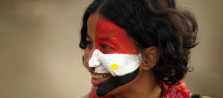 An Egyptian anti-government protester with her face painted in the colours of her national flag stands at Tahrir Square in Cairo on February 4, 2011. Tens of thousands of protesters gathered for sweeping "departure day" demonstrations to force President Hosni Mubarak to quit after he said he would like to step down but fears chaos would result. AFP PHOTO/PATRICK BAZ (Photo credit should read PATRICK BAZ/AFP/Getty Images)