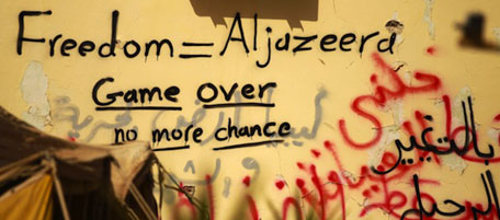 Graffiti praising Al-Jazeera news channel is seen on a wall in the eastern dissident-held Libyan city of Tobruk on February 24, 2011. AFP PHOTO/PATRICK BAZ (Photo credit should read PATRICK BAZ/AFP/Getty Images)
