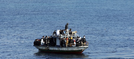 A boatload of would-be migrants believed to be from North Africa is seen moments before being rescued by the Italian Coast Guard in the waters off the Sicilian island of Lampedusa, Italy, Sunday, Feb. 13, 2011. By dawn Saturday, around 3,000 migrants fleeing turmoil in North Africa had arrived by boat on Lampedusa over three days, hundreds more arrived during the day and several more boats were reportedly spotted on the horizon headed for the flat-rock, largely barren fishing island, Italian authorities said. (AP Photo/Daniele La Monaca)