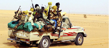 -, SUDAN: (FILES) -- File picture dated 28 July 2004 shows rebels of the Justice and Equality Movement (JEM), fighting Sudanese troops, racing across the desert in the northern part of the western Sudanese Darfur region. A rebel group took hostage as many as 40 African Union (AU) peacekeepers 09 October 2005 in the troubled Darfur region, a day after three troops and two contractors were killed. But news reports early 10 October said most of the 40 AU hostages have been freed. The abductions took place near the town of Tine on Sudan's frontier with Chad and the kidnappers were believed to be members of a dissident faction of Darfur's rebel JEMmovement, according to AU spokesman Noureddine Mezni. AFP PHOTO/DESIREY MINKOH (Photo credit should read DESIREY MINKOH/AFP/Getty Images)