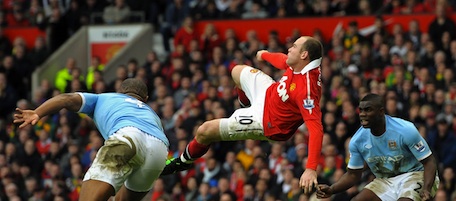 Manchester United's English striker Wayne Rooney (2nd L) scores their second goal between Manchester City's Belgian midfielder Vincent Kompany (L) and English defender Micah Richards (R) during the English Premier League football match between Manchester United and Manchester City at Old Trafford in Manchester, north-west England on February 12, 2011. AFP PHOTO/ANDREW YATES

RESTRICTED TO EDITORIAL USE Additional licence required for any commercial/promotional use or use on TV or internet (except identical online version of newspaper) of Premier League/Football League photos. Tel DataCo +44 207 2981656. Do not alter/modify photo (Photo credit should read ANDREW YATES/AFP/Getty Images)