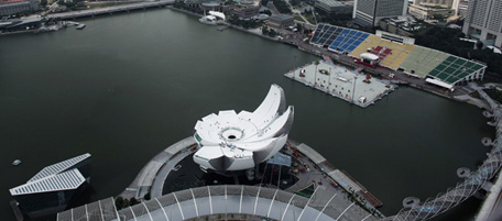 SINGAPORE - FEBRUARY 08: Construction workers complete work on the roof of the Singapore ArtScience Museum on February 8, 2011 at Marina Bay Sands, Singapore. Designed by renowned architect Moshe Safdie, the 50,000 sqft, lotus- inspired building, is the worldÕs first ArtScience Museum and will house 21 galleries. The large roof dish collects rain water which falls through the center atrium of the building as a waterfall, at night the roof then transforms into an amphitheatre displaying a light and laser show with the Singapore skyline as a backdrop. The museum is set to open to the public on the 17th of February at 1.18 pm, the time chosen by the projects Feng Shui master. (Photo by Chris McGrath/Getty Images)