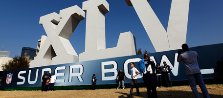 DALLAS, TX - JANUARY 30: Football fans gather around a large Super Bowl XLV display on January 30, 2011 in downtown Dallas, Texas. Cowboys Stadium will host Super Bowl XLV on February 6, 2011 between the Pittsburgh Steelers and the Green Bay Packers in Arlington, Texas (Photo by Tom Pennington/Getty Images)