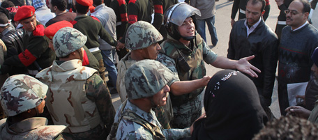 CAIRO, EGYPT - FEBRUARY 13: An Egyptian soldier answers a protester after the army ordered demonstrators' encampments closed in Tahrir Square on February 13, 2011 in Cairo, Egypt. Two days after the resignation of Hosni Mubarak, the Egyptian army is asserting its control. (Photo by John Moore/Getty Images)