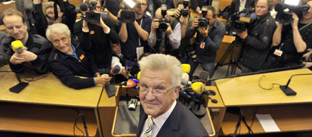 Winfried Kretschmann, top candidate of the German Green Party, poses in the parliament after the first exit poll projections for the state elections in German Federal state Baden-Wuerttemberg were released on TV in Stuttgart, southern Germany, on March 27, 2011. Chancellor Angela Merkel's conservatives lost power in their German heartland after nearly six decades, exit polls showed with the Greens likely to lead their first-ever state government. AFP PHOTO / BORIS ROESSLER GERMANY OUT (Photo credit should read BORIS ROESSLER/AFP/Getty Images)