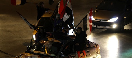 Supporters of Syrian President Bashar al-Assad bear flags and portraits of the president as they demonstrate their support to their leader in Damascus' Old City on March 26, 2011. AFP PHOTO /LOUAI BESHARA (Photo credit should read LOUAI BESHARA/AFP/Getty Images)