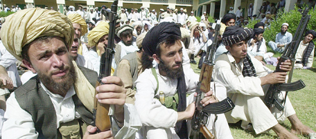 MIR ALI, PAKISTAN: Armed tribesman listen to speeches of their leaders in an anti US meeting 04 May 2002 at Mir Ali, in Pakistan's federally administered North Waziristan Agency bordering Afghanistan, about 160 miles to the west of Peshawar stand in defiance against joint U.S-Pakistan operations against suspected Al Qaeda-Taliban network. AFP PHOTO/TARIQ MAHMOOD. (Photo credit should read TARIQ MAHMOOD/AFP/Getty Images)