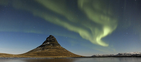 SNAEFELLSNES, ICELAND - FEBRUARY 18: EXCLUSIVE. The Aurora Borealis over Fjord Grundarfjorour on February 18, 2011 in Snaefellsnes, Iceland. These incredible aurora images may fool you into thinking they were taken in broad daylight. Kerstin Langenberger spent 300 hours chasing The Aurora Borealis by full moon to capture this rarely seen set of images. They show how the mystically beautiful landscape of the untouched UNESCO World Heritage Site of Thingvellir National Park was cloaked in a multicoloured explosion of light. The curtains of green and purple light make the brightly lit snow capped mountains and crystal clear lakes look like they are part of an alien world, haunted by ghostly mirages. Aurora's are caused by charged particles being blasted through space from the sun. These are attracted to the Earth's magnetic field at the North and South poles. The energy released by the particles striking the atmosphere of the Earth at about 150 km above the surface of our planet causes the jaw-dropping displays of light. (Photo by Kerstin Langenberger / Barcroft Media / Getty Images)