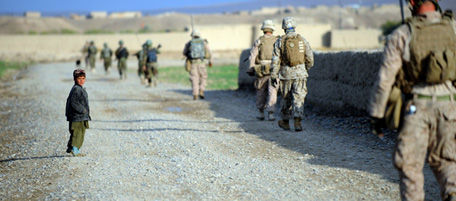 US Marines of the 2nd Batallion, 1st Marines Weapons Company return to the Gorgak base after patrol along with Afghanistan National Army (ANA) soldiers in Laki, downsouth Garmser in Helmand Province on March 2, 2011. One in three Afghan soldiers still leave the army each year, but NATO remains on track to raise the number of security forces to 305,000 by October 2011, an alliance general said. Boosting the ranks of Afghanistan's security forces is a vital element of NATO's plan to begin handing command of the battlefield to Afghans this year, and start withdrawing some foreign troops, with the goal of giving them full control nationwide by 2014. AFP PHOTO / ADEK BERRY (Photo credit should read ADEK BERRY/AFP/Getty Images)