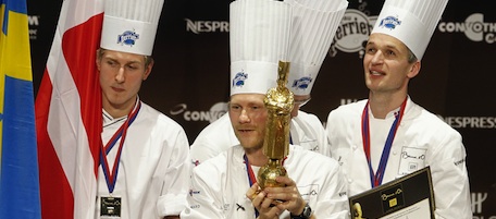 Rasmus Kofoed of Denmark, center, celebrates on the podium with his teammates after winning the "Bocuse d'Or" (Golden Bocuse) trophy, at the 13th World Cuisine contest, in Lyon, central France, Wednesday, Jan. 26, 2011. The contest, a sort of world cup of the cuisine, was started in 1987 by Lyon chef Paul Bocuse to reward young international culinary talents. (AP Photo/Laurent Cipriani)