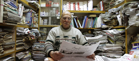 A Syrian shop keeper reads a newspaper inside his store in Damascus on March 18, 2011. AFP PHOTO/STR (Photo credit should read -/AFP/Getty Images)