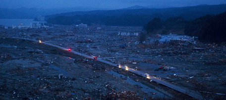 Japanese vehicles pass through the ruins of the leveled city of Minamisanriku, in northeastern Japan, Tuesday March 15, 2011. (AP Photo/David Guttenfelder)