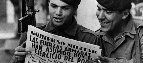 Two army soldiers read a newspaper in the Buenos Aires Plaza de Mayo March 24, 1976 after a military coup led by Gen. Jorge Rafael Videla ousted President Isabel Peron. During the dictatorship's so-called Dirty War, the armed forces waged a campaign against leftist and other political opponents that left at least 9,000 poeple killed or disappeared, by the government's count. Human rights groups put the figure closer to 30,000. The extent of abuses was made public after Argentina returned to democracy in 1983. Headline reads, "Military Governement - Armed Forces Assume Power." (AP Photo)