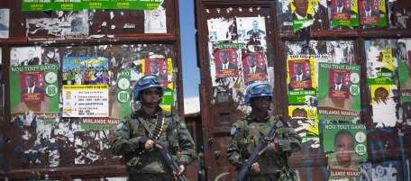 UN peacekeepers from Brazil stand guard at the gate of a polling station ahead of the second round of elections in Cite Soleil, Port-au-Prince, Haiti, Saturday March 19, 2011. Haiti will hold runoff elections on Sunday. (AP Photo/Ramon Espinosa)