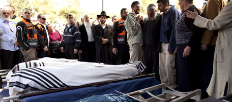 JERUSALEM, ISRAEL - MARCH 13: (ISRAEL OUT) Mourners stand around the bodies of Ehud Fogel, 36, his wife Ruti, 35, and their children, 11-year-old Yoav, 4-year-old Elad, and 3-month-old Hadas, during their funeral on March 13, 2011 in Jerusalem, Israel. The five members of the Fogel family were stabbed to death at their home in the West Bank settlement of Itamar. (Photo by Uriel Sinai/Getty Images)