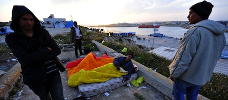 Tunisian would-be immigrants sleep near the port in Lampedusa on March 26, 2011. The Italian government says more than 15,000 migrants have arrived on Lampedusa from Tunisia since the ouster of president Zine El Abidine Ben Ali in mid-January, including around 13,500 in the last 20 days alone. AFP PHOTO / ALBERTO PIZZOLI (Photo credit should read ALBERTO PIZZOLI/AFP/Getty Images)