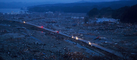Japanese vehicles pass through the ruins of the leveled city of Minamisanriku, in northeastern Japan, Tuesday March 15, 2011. (AP Photo/David Guttenfelder)