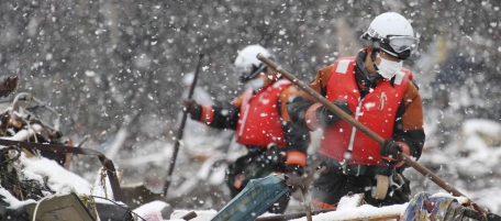 Firefighters search for survivors in the snow in Minamisanriku, northern Japan, Wednesday, March 16, 2011, after Friday's earthquake and tsunami. (AP Photo/The Yomiuri Shimbun, Hiroaki Ono) JAPAN OUT, MANDATORY CREDIT